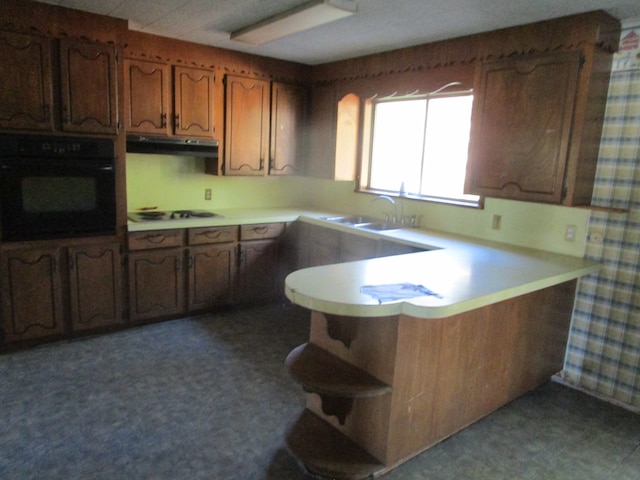 kitchen with oven, sink, white gas cooktop, and kitchen peninsula