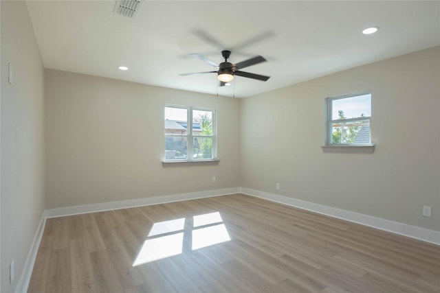 empty room with light hardwood / wood-style floors and ceiling fan