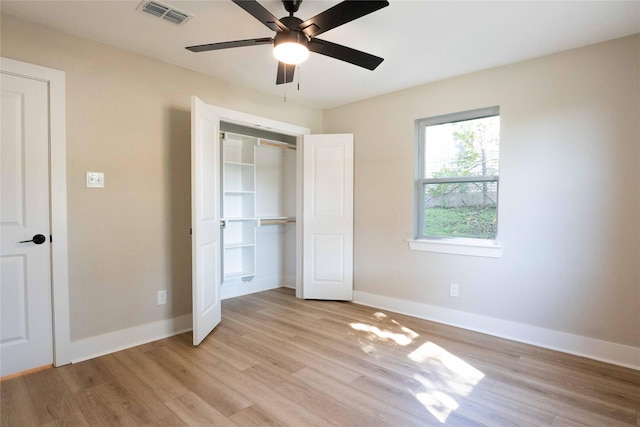 unfurnished bedroom featuring ceiling fan, a closet, and light hardwood / wood-style flooring