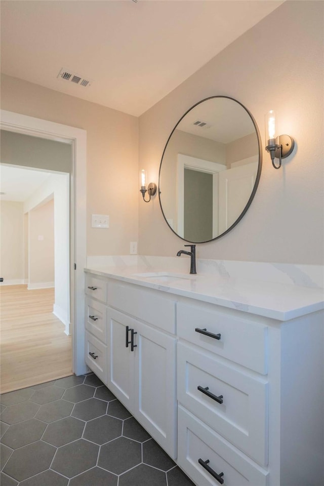 bathroom with tile patterned flooring and vanity