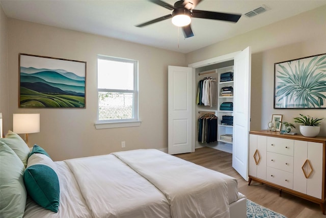 bedroom with ceiling fan, wood-type flooring, and a closet