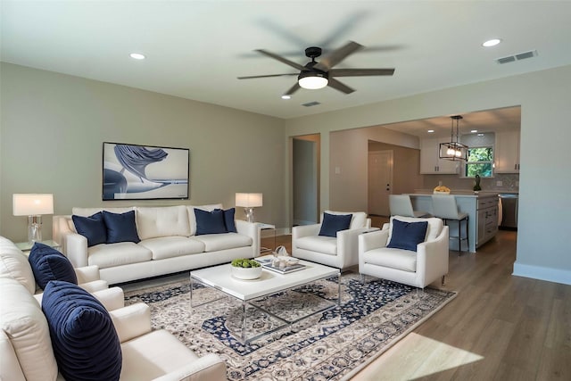 living room with hardwood / wood-style floors and ceiling fan