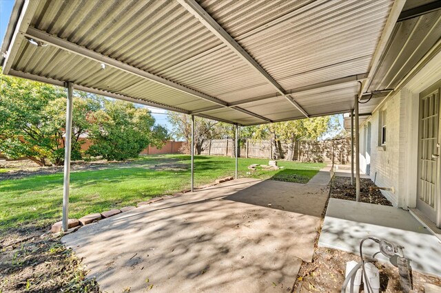 back of house featuring central AC unit, a patio area, and a yard