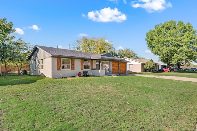 ranch-style home featuring a front yard and central AC