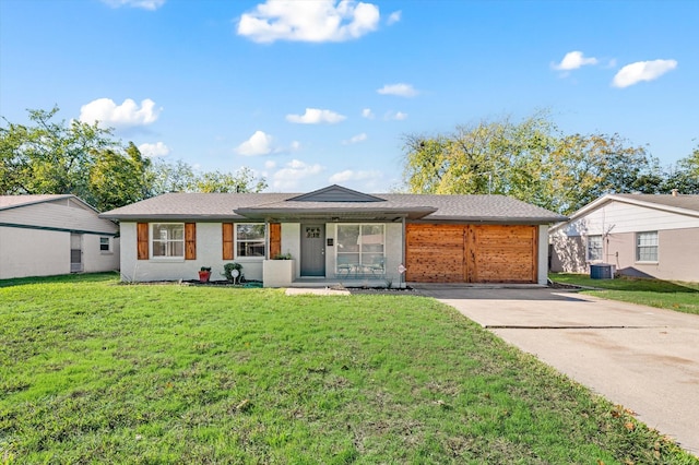 ranch-style house featuring cooling unit, concrete driveway, and a front yard