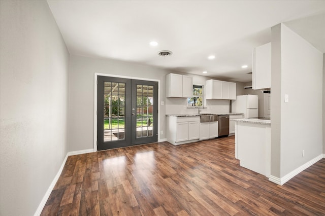 kitchen with dishwasher, dark wood-type flooring, french doors, white cabinets, and white refrigerator