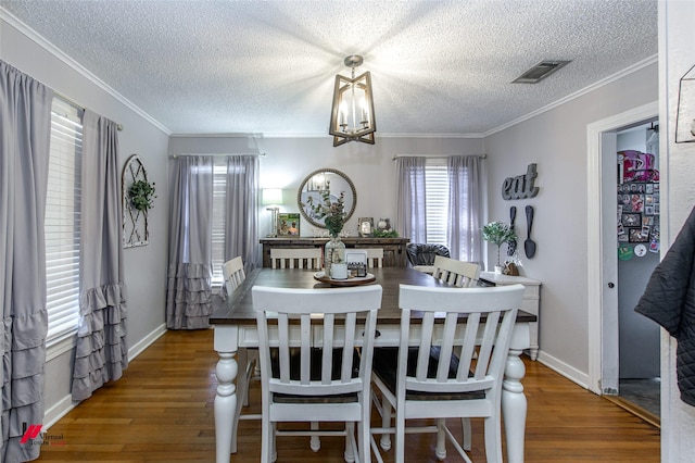 3756 Greenway Pl, Shreveport, LA 71105 - dining area with wood finished floors, a textured ceiling, a chandelier, baseboards, and crown molding
