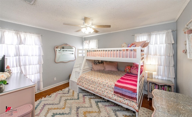 3756 Greenway Pl, Shreveport, LA 71105 - bedroom with wood finished floors, crown molding, a textured ceiling, baseboards, and a ceiling fan