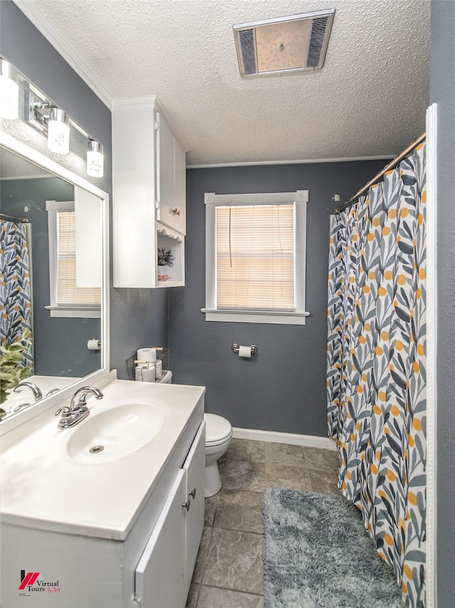 bathroom featuring a textured ceiling, vanity, toilet, and ornamental molding