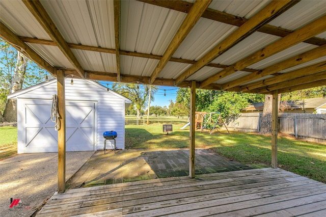 wooden deck with a storage shed and a yard