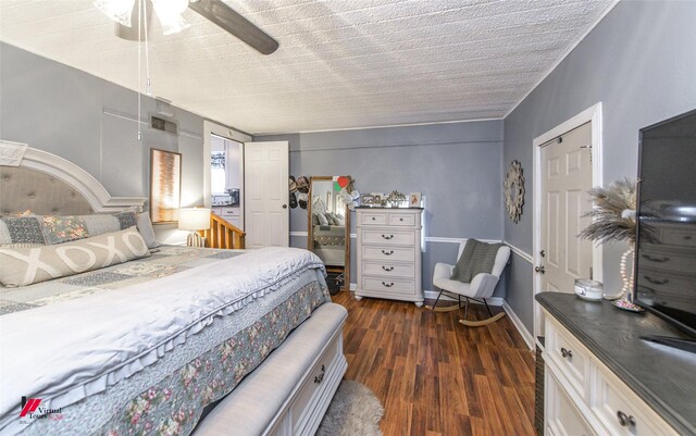 bedroom featuring a textured ceiling, ceiling fan, and dark hardwood / wood-style floors