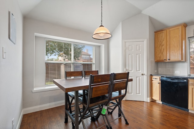 dining area featuring dark hardwood / wood-style flooring and vaulted ceiling