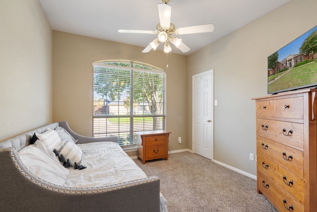 bedroom featuring ceiling fan, light carpet, and multiple windows