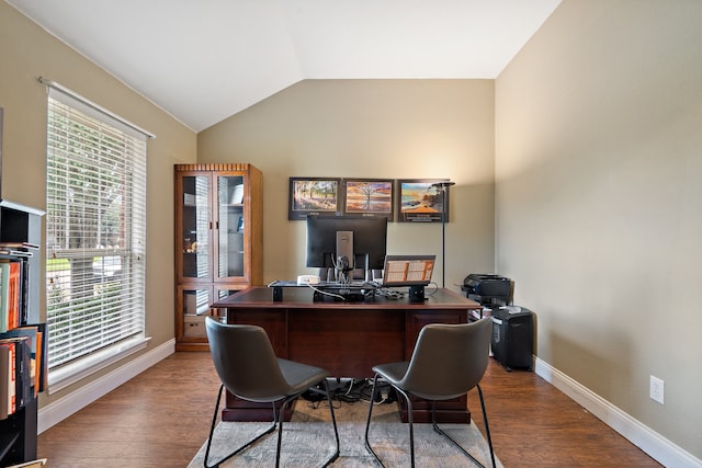 home office featuring hardwood / wood-style flooring, a wealth of natural light, and lofted ceiling