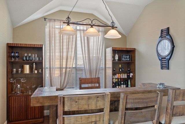 bar with vaulted ceiling and hanging light fixtures