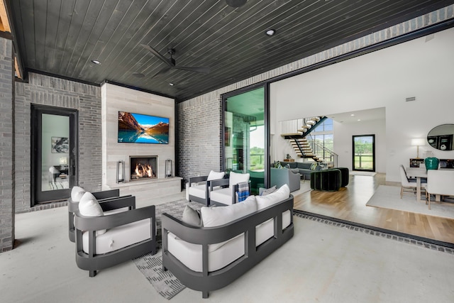 view of patio featuring an outdoor living space with a fireplace and ceiling fan