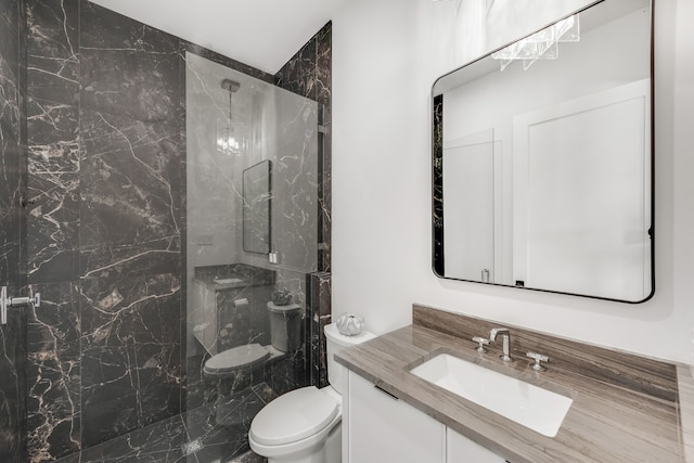 bathroom featuring vanity, toilet, and a shower with door