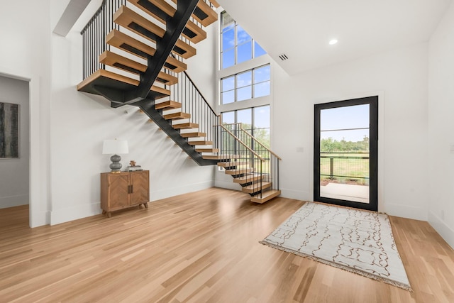 7517 Sunnyview Ln, Flower Mound, TX 75022 - foyer entrance featuring stairs, wood finished floors, visible vents, a high ceiling, and baseboards