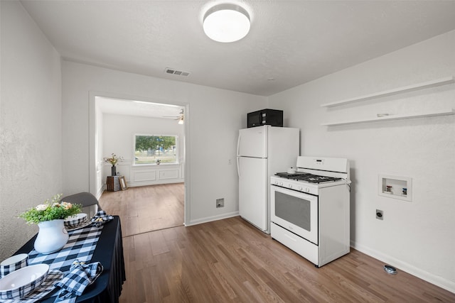 kitchen featuring white appliances, light hardwood / wood-style flooring, and ceiling fan