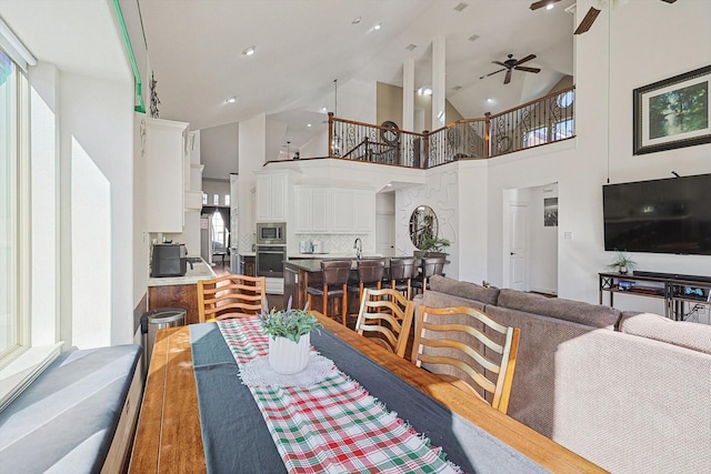 dining room featuring high vaulted ceiling and ceiling fan