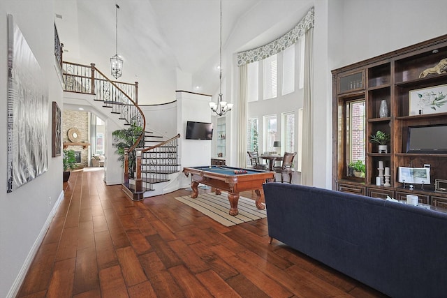 game room featuring pool table, dark hardwood / wood-style flooring, and a towering ceiling