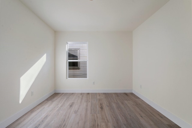 empty room with light hardwood / wood-style flooring