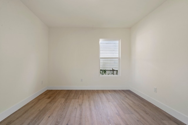 empty room with light hardwood / wood-style flooring