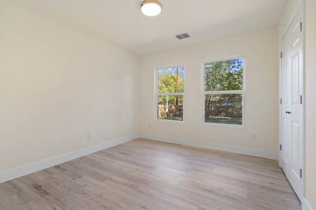 empty room with light hardwood / wood-style flooring