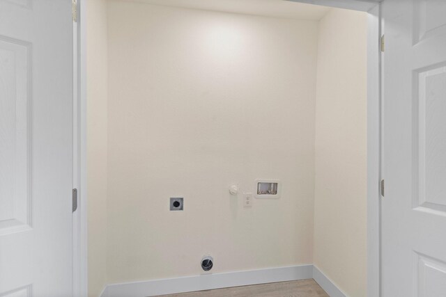 clothes washing area with washer hookup, electric dryer hookup, light hardwood / wood-style floors, and gas dryer hookup