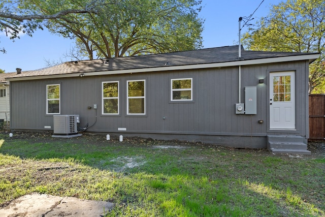 back of property featuring a yard and central AC unit