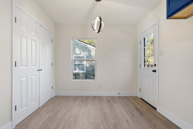 entrance foyer with light hardwood / wood-style floors and a wealth of natural light