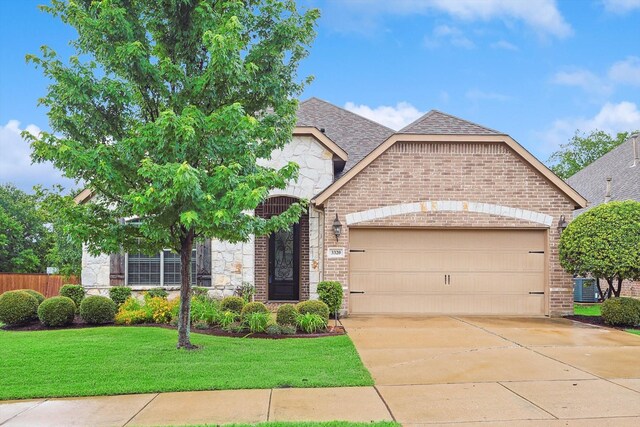 view of front of home with a garage, central air condition unit, and a front lawn