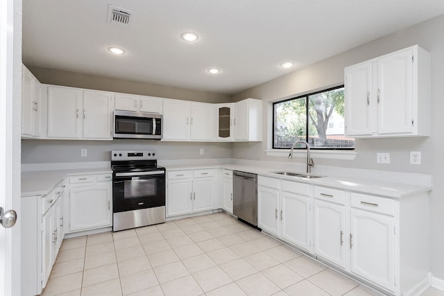 kitchen with white cabinetry, sink, and stainless steel appliances