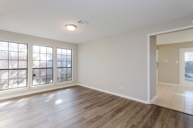 empty room featuring hardwood / wood-style floors and a textured ceiling