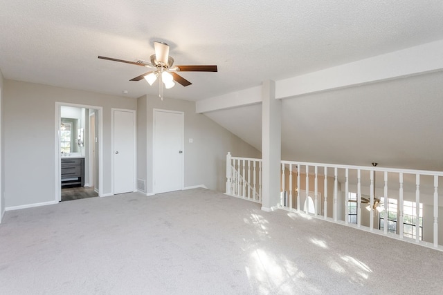 bonus room with a textured ceiling, ceiling fan, carpet floors, and lofted ceiling