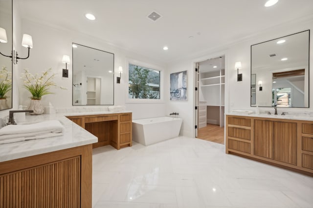 bathroom featuring a chandelier, vanity, a tub to relax in, and crown molding