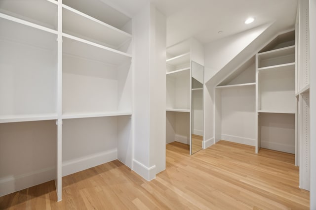 spacious closet featuring hardwood / wood-style floors