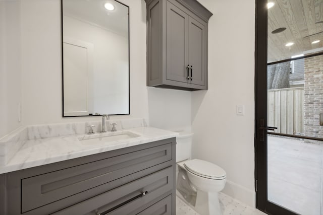 bathroom featuring vanity, toilet, and a shower with shower door