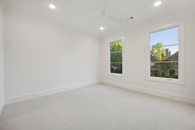 unfurnished room featuring carpet, ceiling fan, and crown molding