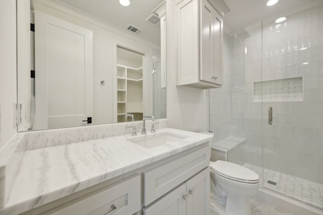 bathroom featuring vanity, toilet, and walk in shower