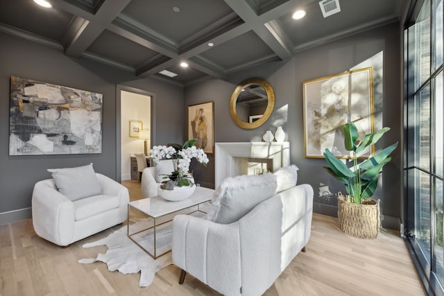 living room with light wood-type flooring, a fireplace, ornamental molding, coffered ceiling, and beamed ceiling