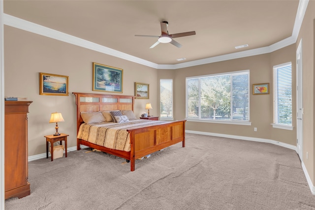 carpeted bedroom featuring ensuite bath, ceiling fan, and crown molding