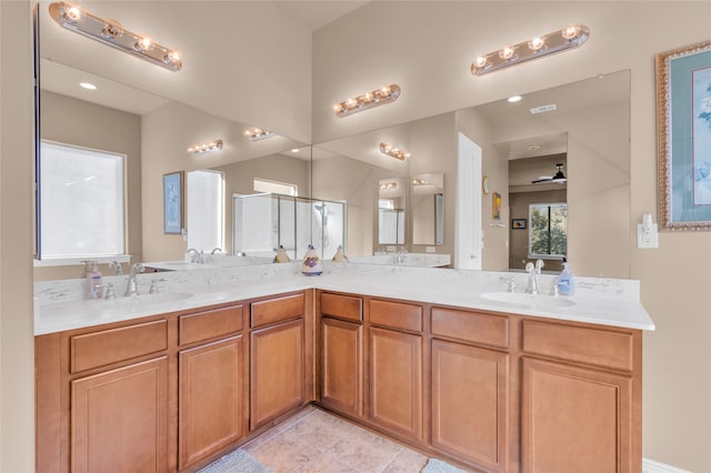 laundry room with cabinets, light tile patterned floors, independent washer and dryer, and sink