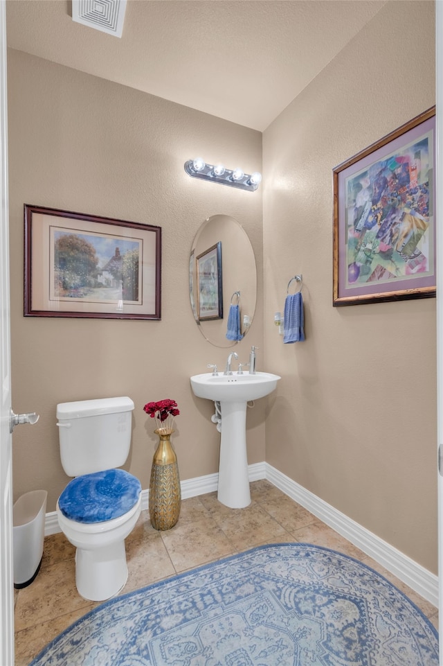 bathroom featuring toilet and tile patterned floors