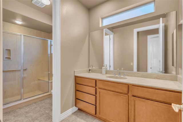 bathroom with tile patterned flooring, vanity, and a shower with shower door