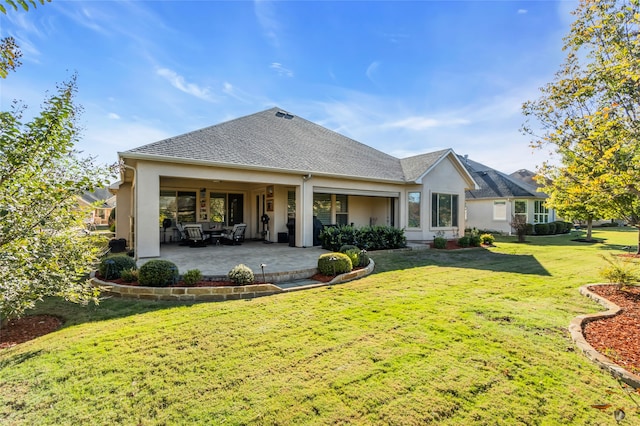 back of house featuring a lawn and a patio area