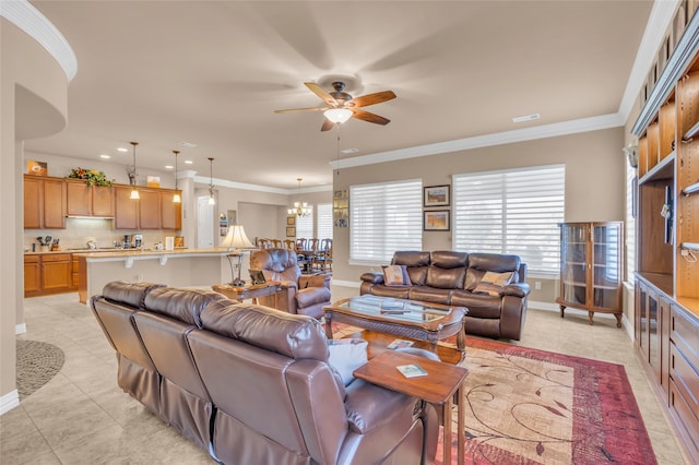 kitchen with light stone countertops, appliances with stainless steel finishes, hanging light fixtures, and sink