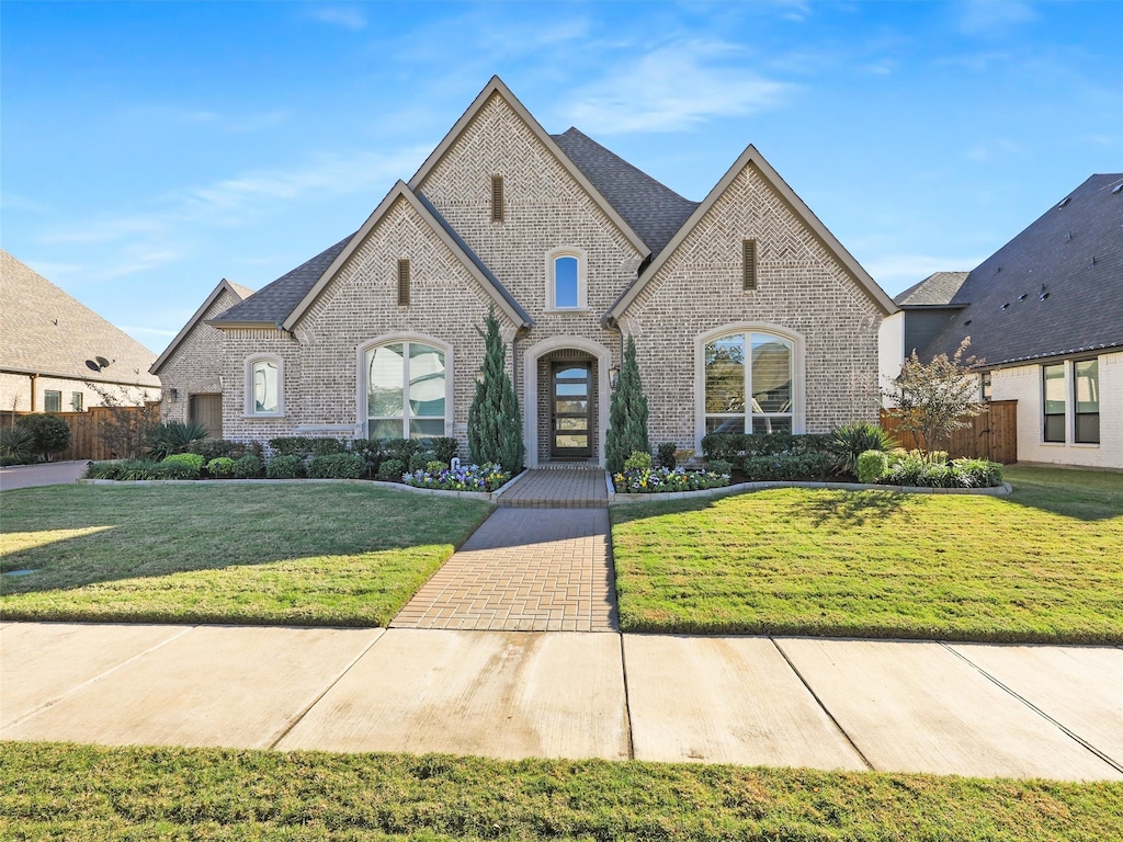 french provincial home featuring a front lawn