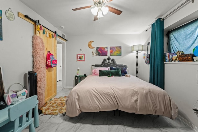 bedroom featuring a barn door and ceiling fan