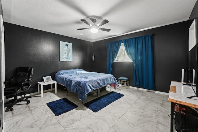 bedroom with ceiling fan and a textured ceiling